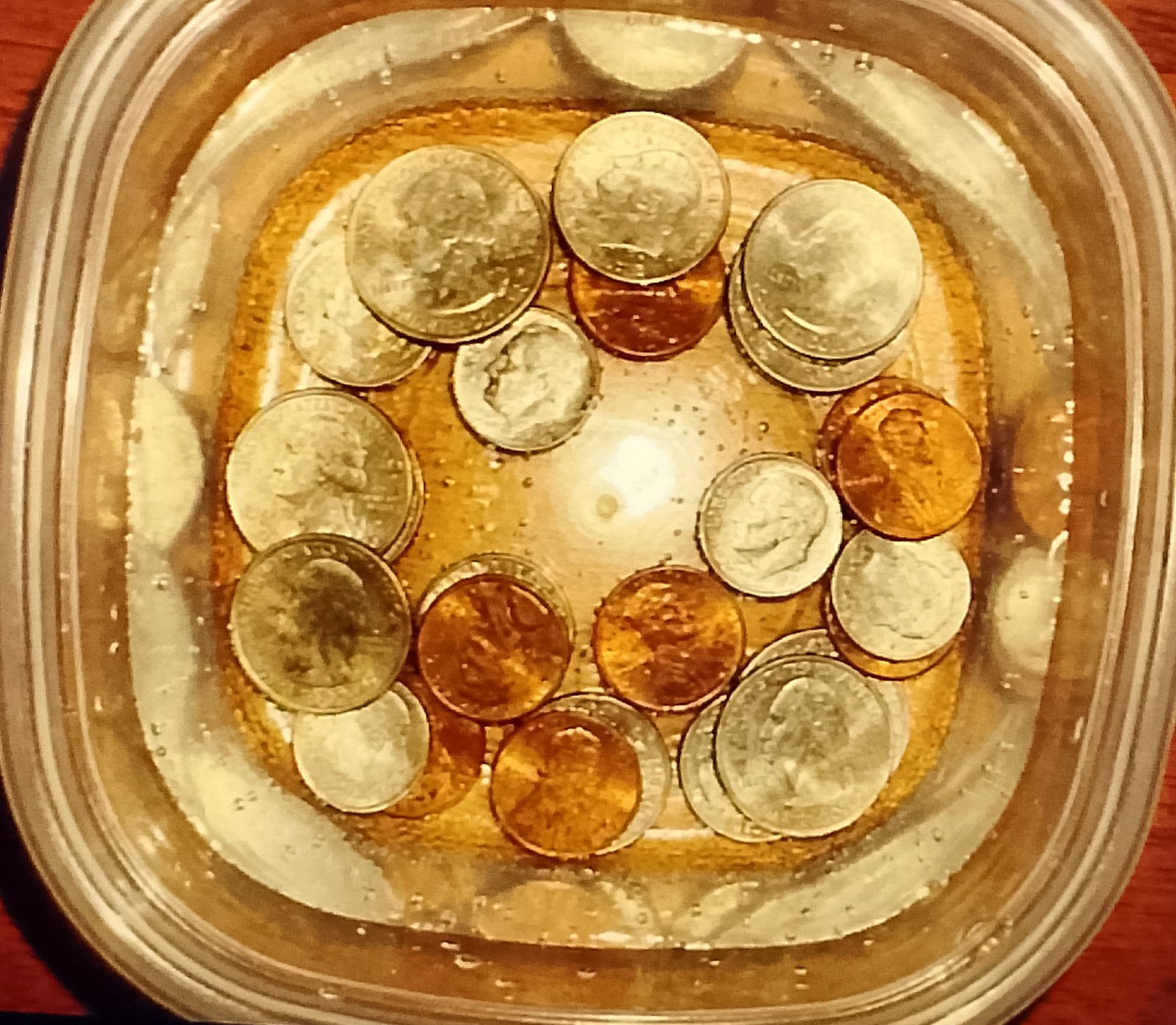 Top-down shot of coins submerged in the water,