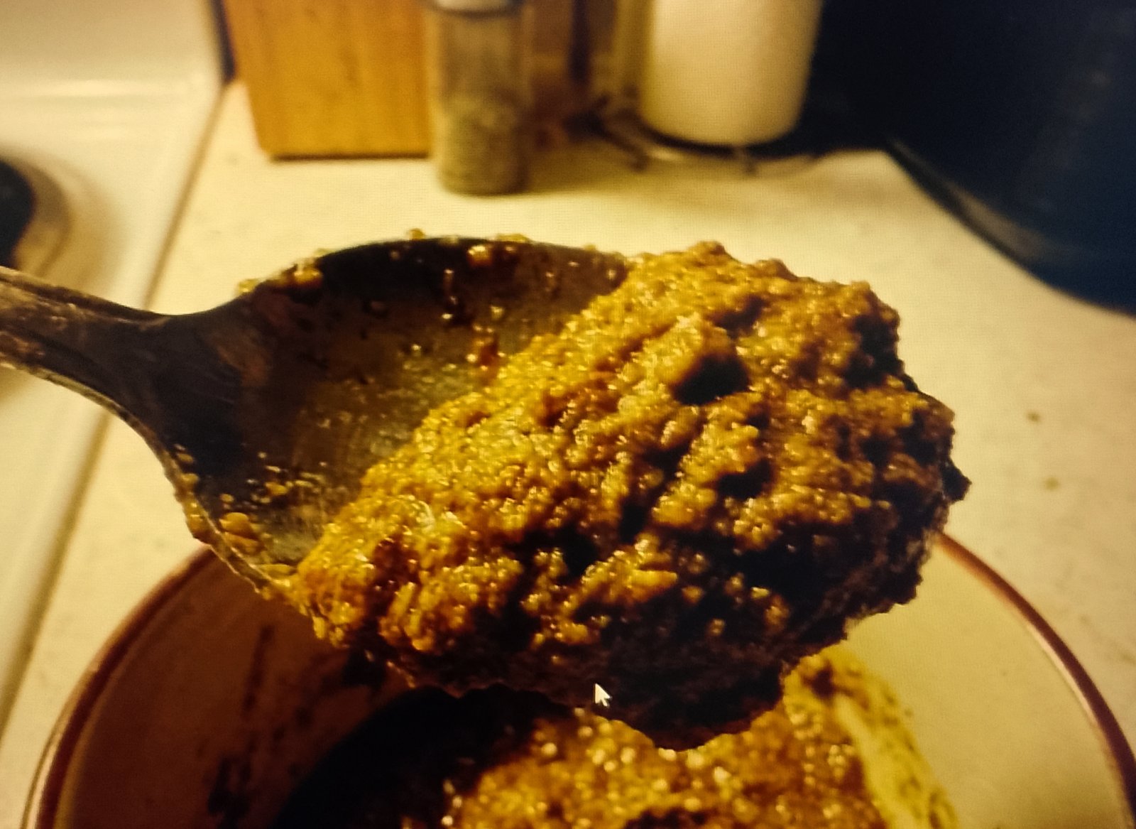 paste on a spoon Baking soda paste with a frosting-like consistency on a spoon