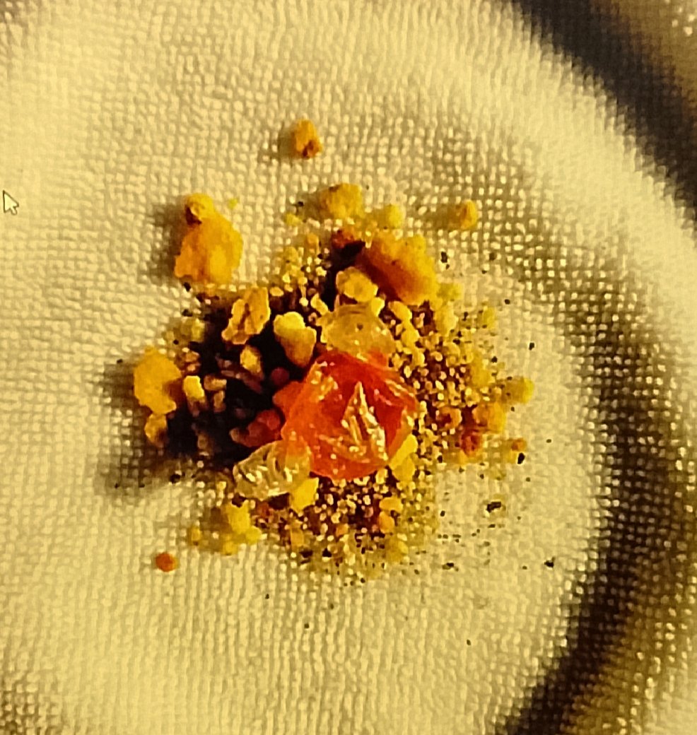crunchy crumbs Crumbs and small debris emptied from a backpack onto a towel