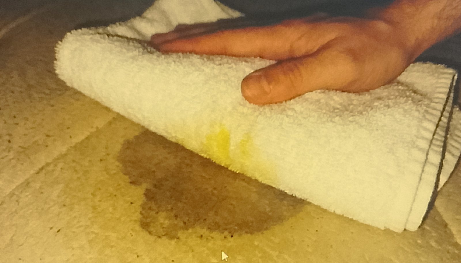 dry towel Blotting yellow sweat stain from pillow with white towel