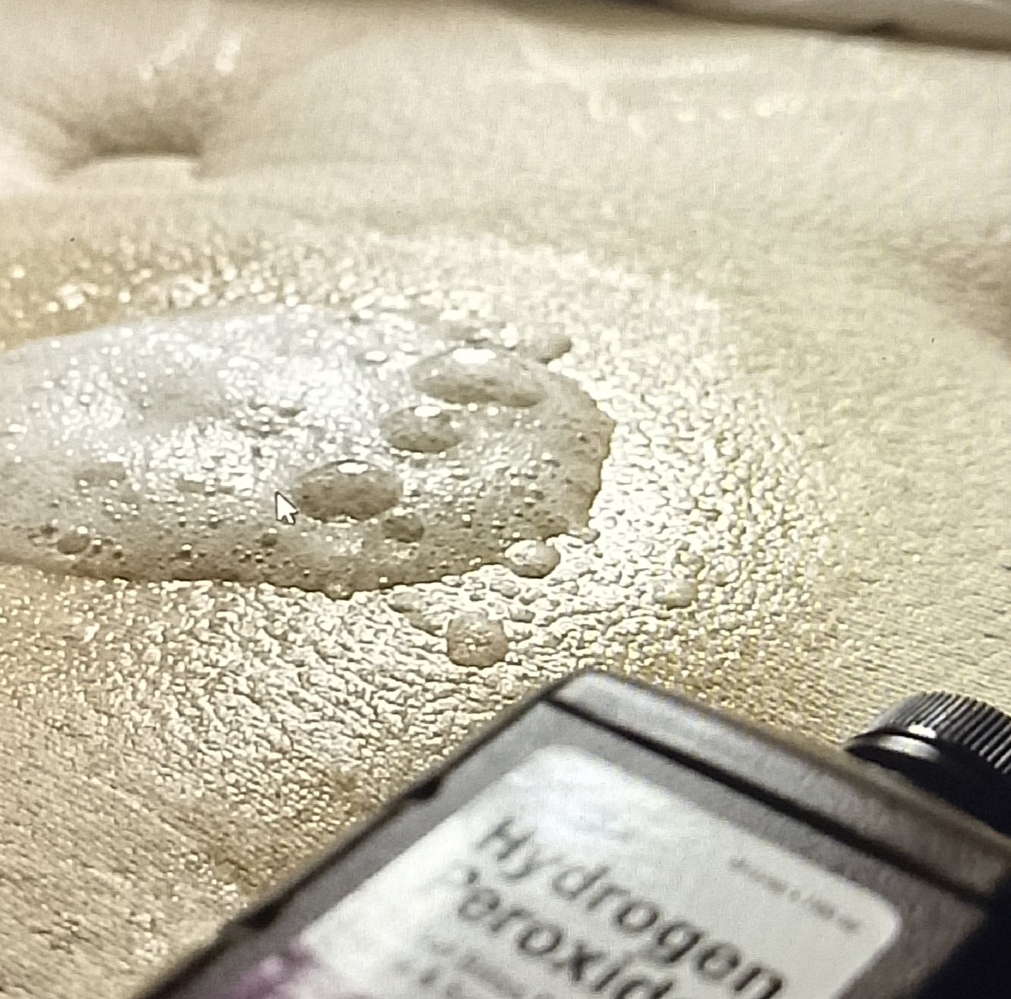 Applying foam mixture to yellow mattress stains