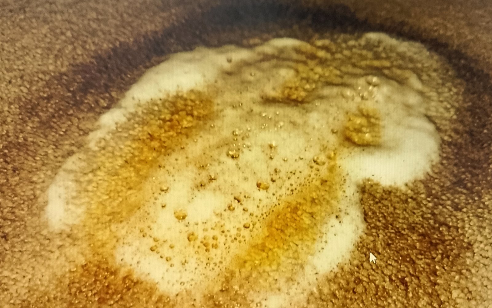 Spraying hydrogen peroxide mix on yellow mattress stain