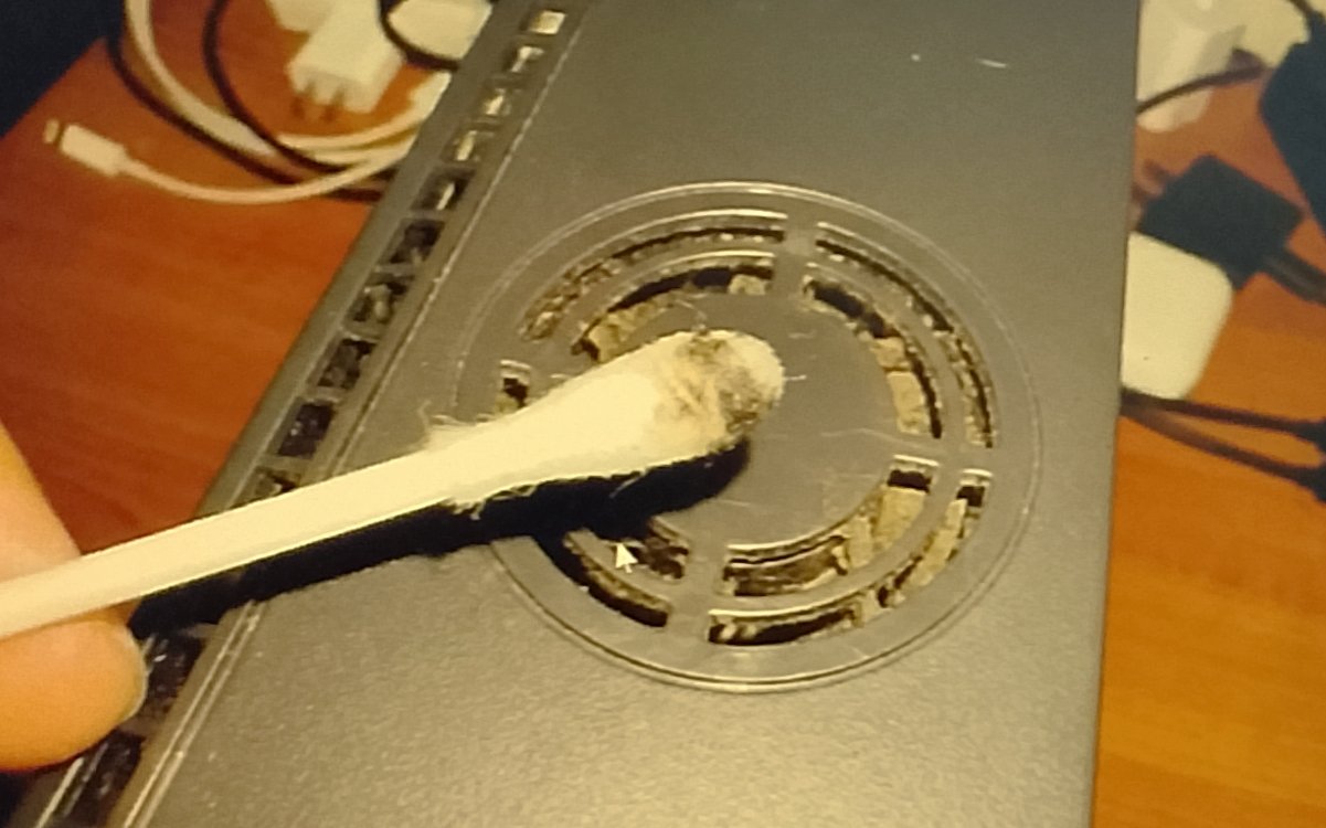 Q-tip cleaning the inside edge of Xbox vent holes