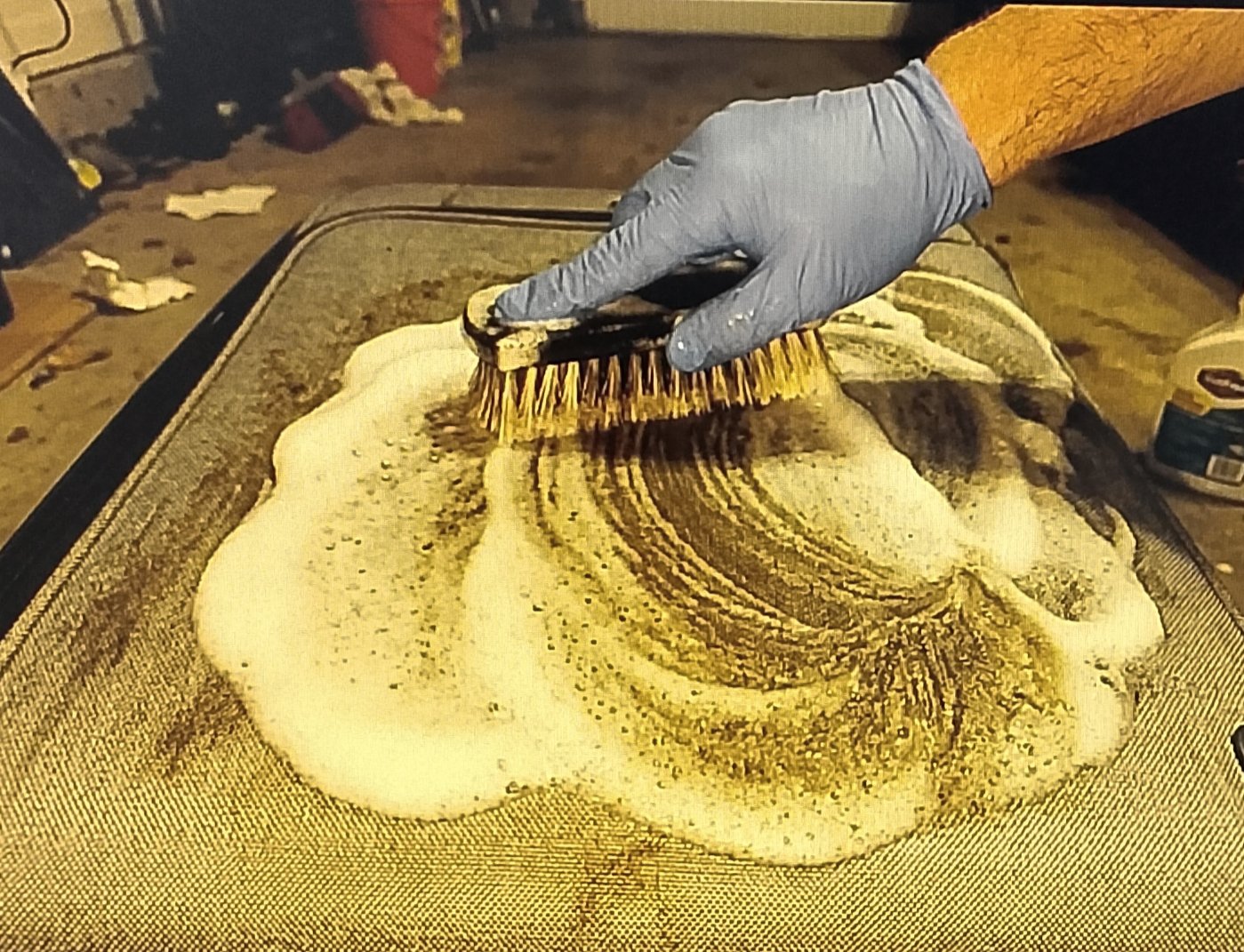 clean dirty fabric luggage Applying dry soap foam to nylon luggage with a brush