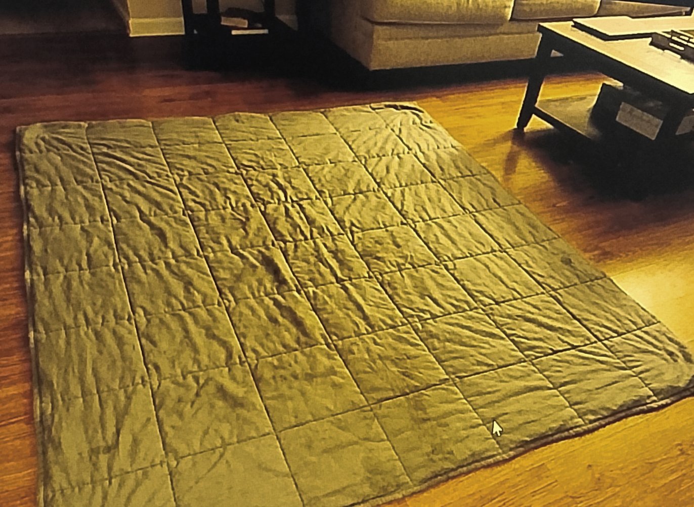 Weighted blanket insert laid out flat on the floor showing grid stitching
