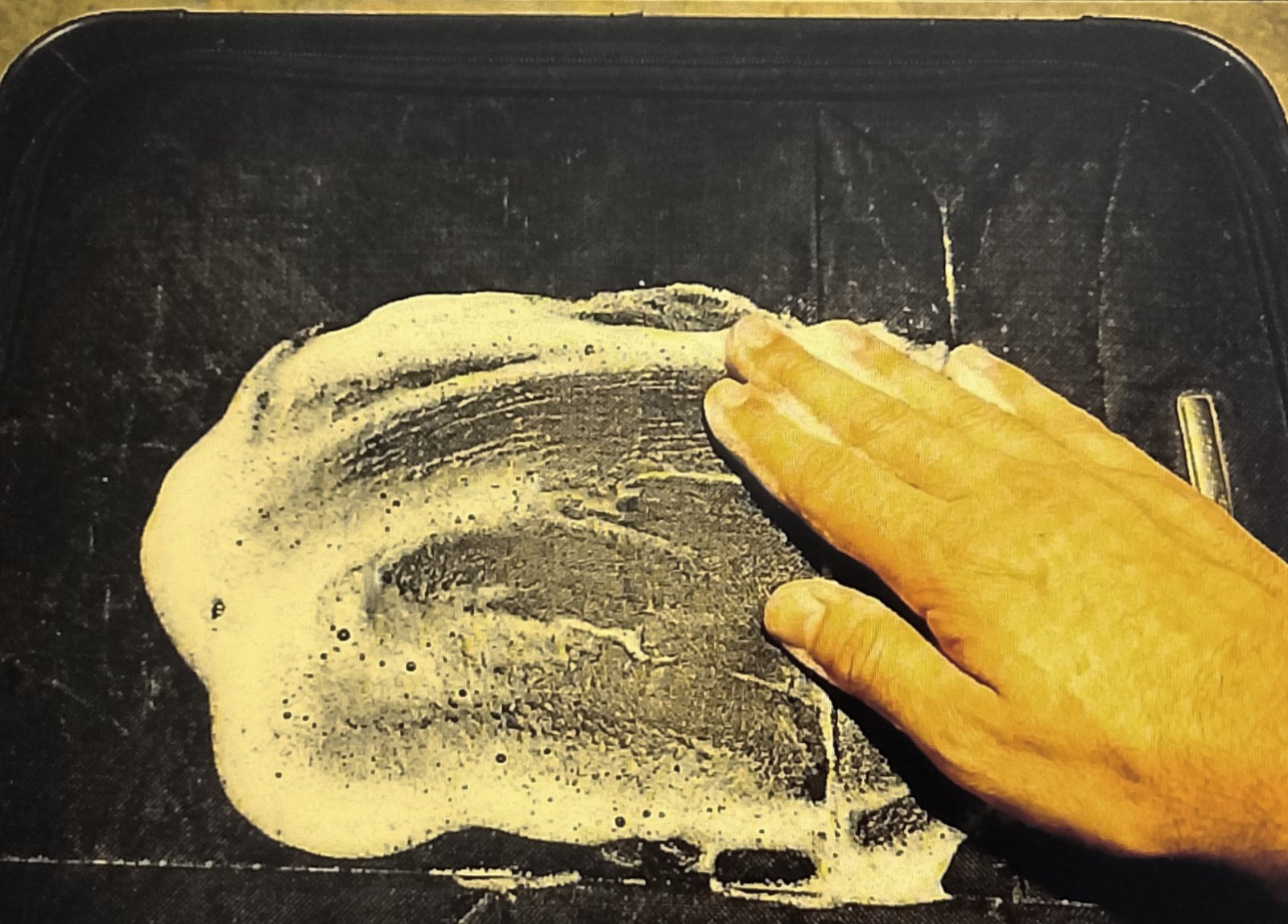 white soap foam on suitcase Applying dry soap foam to fabric luggage to clean without soaking