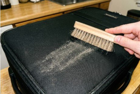 How to Clean Briggs and Riley Luggage at Home 1 Dry brushing dirt off Briggs and Riley ballistic nylon luggage