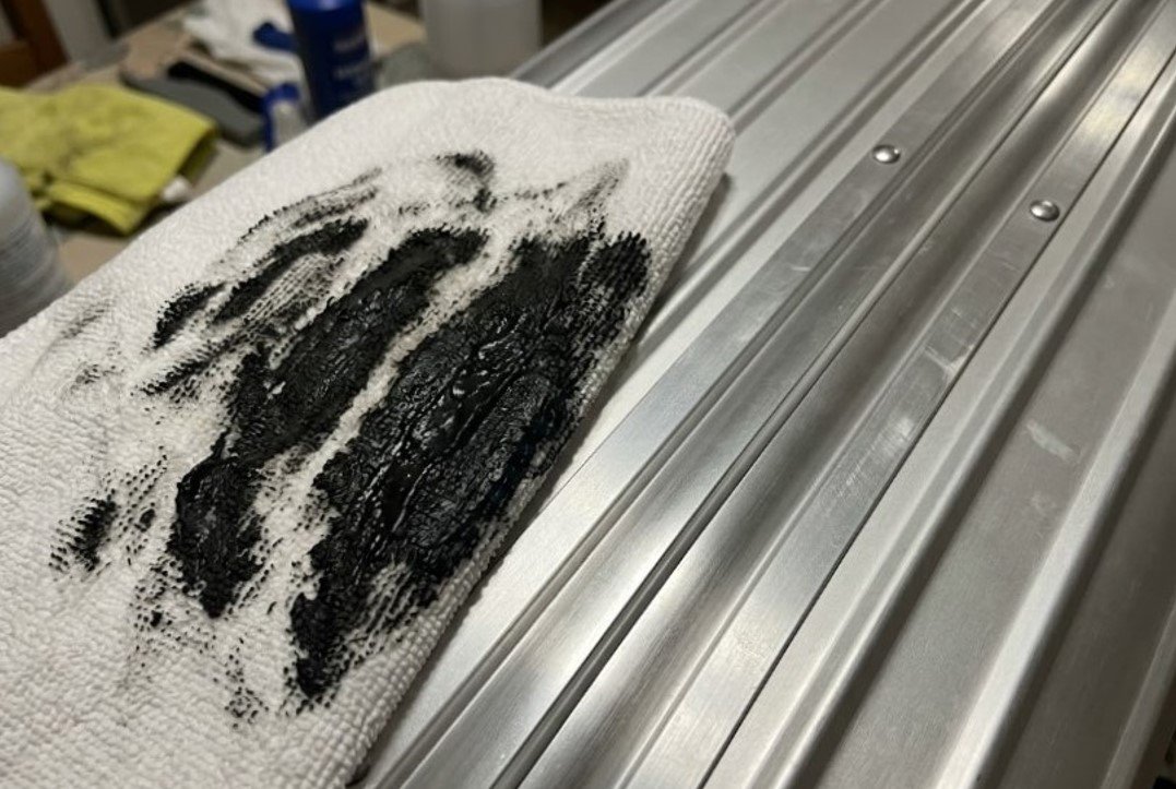 Removing rubber scuff marks from Rimowa aluminum luggage with 70% isopropyl alcohol on microfiber cloth