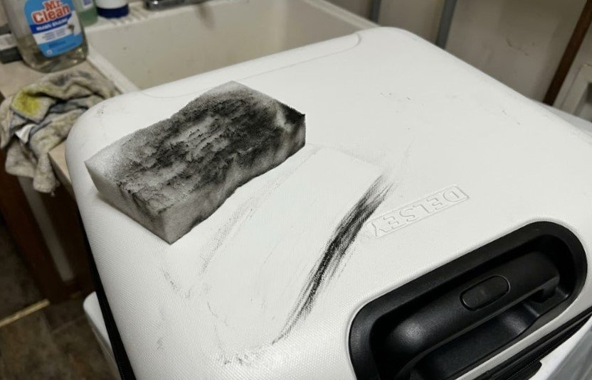a Magic Eraser half covered in black grime Magic Eraser half-covered in black grime